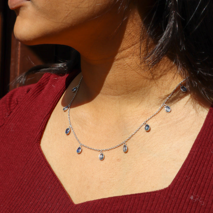 A closeup image of a girl wearing Classic Kyanite Charm Necklace -2 by Carat For You 