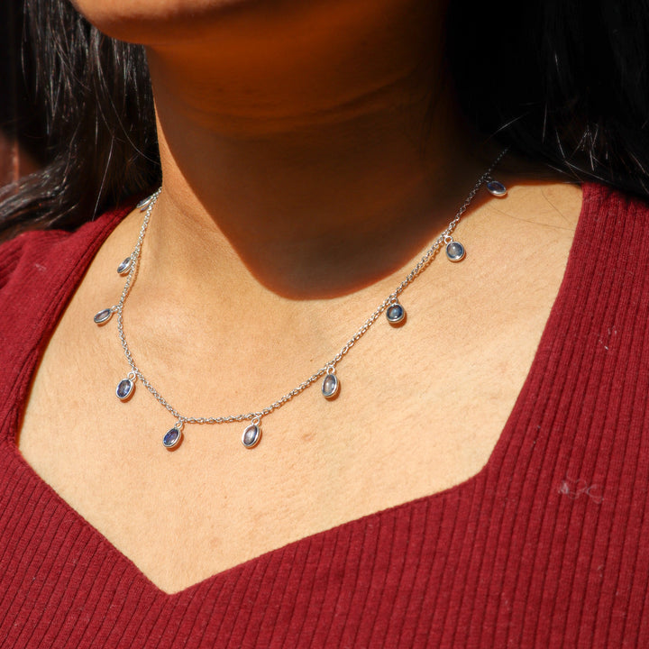 A closeup image of a girl wearing Classic Kyanite Charm Necklace -3 by Carat For You 