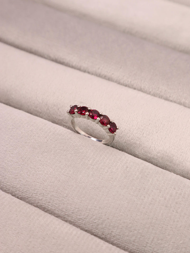 A closeup image of Dainty Garnet Minimalist Ring  by Carat For You on a grey tray