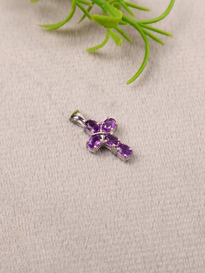 A closeup image of Divine Amethyst Cross Pendant  by carat For You on a grey background