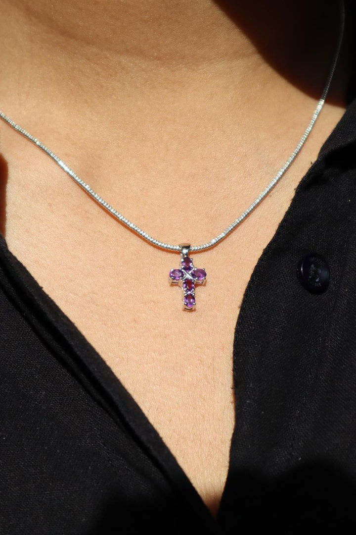 A closuep image of a girl wearing Divine Amethyst Cross Pendant -5 by Carat For You 