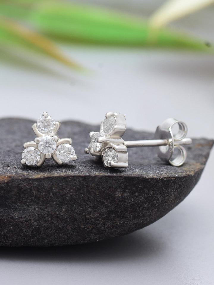 Elegant Trio Cluster Moissanite Stud Earrings by Carat For You on black rock