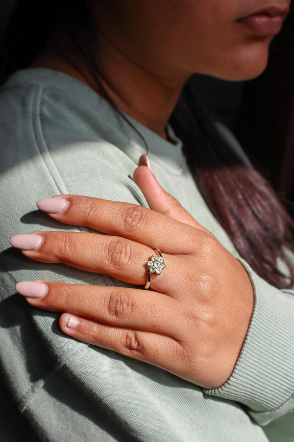 Model in green sweater wearing Floral Peridot Flower Ring