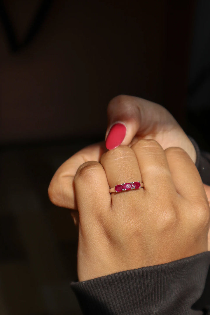 Girl in black sweater wearing Natural Ruby Three Stone Ring in 925 Sterling Silver