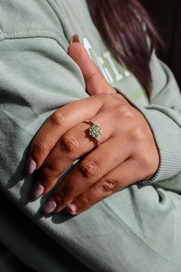 Model in green sweater wearing Floral Peridot Flower Ring