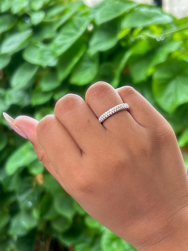 Model wearing Eternal Spark Moissanite Band Ring by Carat For you on natural green leaves background