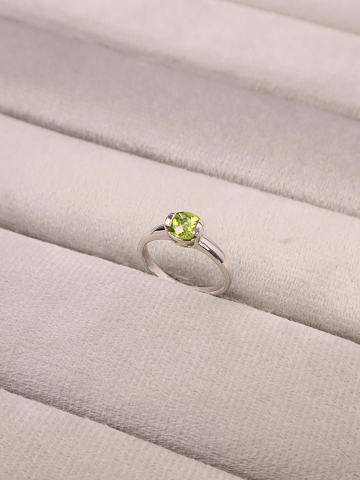 A closeup image of Peridot Radiant Ring -1 by Carat For You on a grey tray 